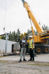 Foreman and client discussion work on construction site Architect with builder