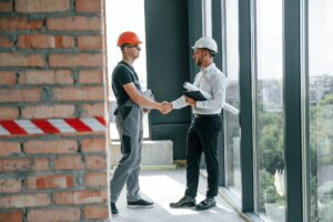 Manager with foreman are working on the construction site together