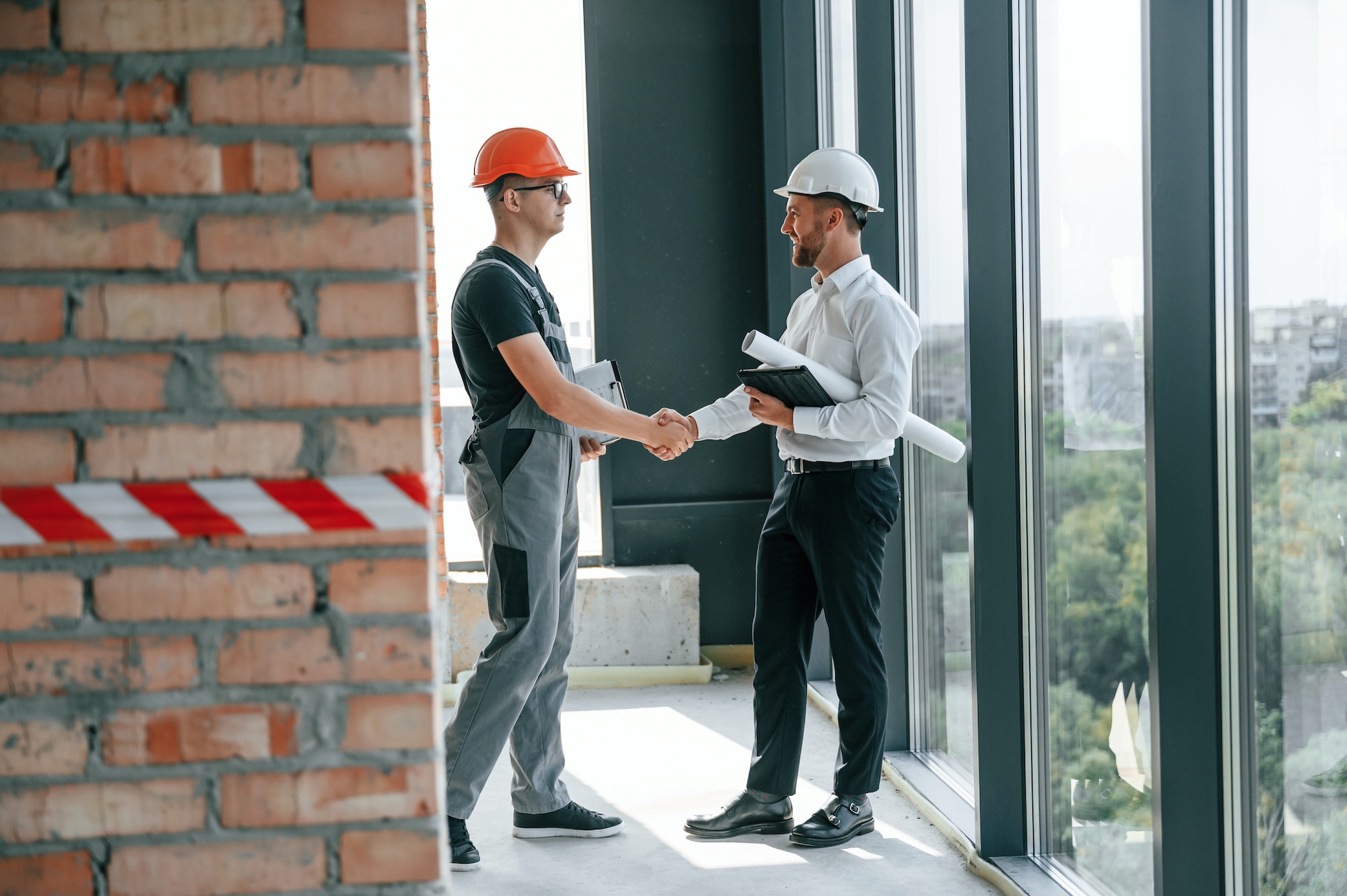 Manager with foreman are working on the construction site together